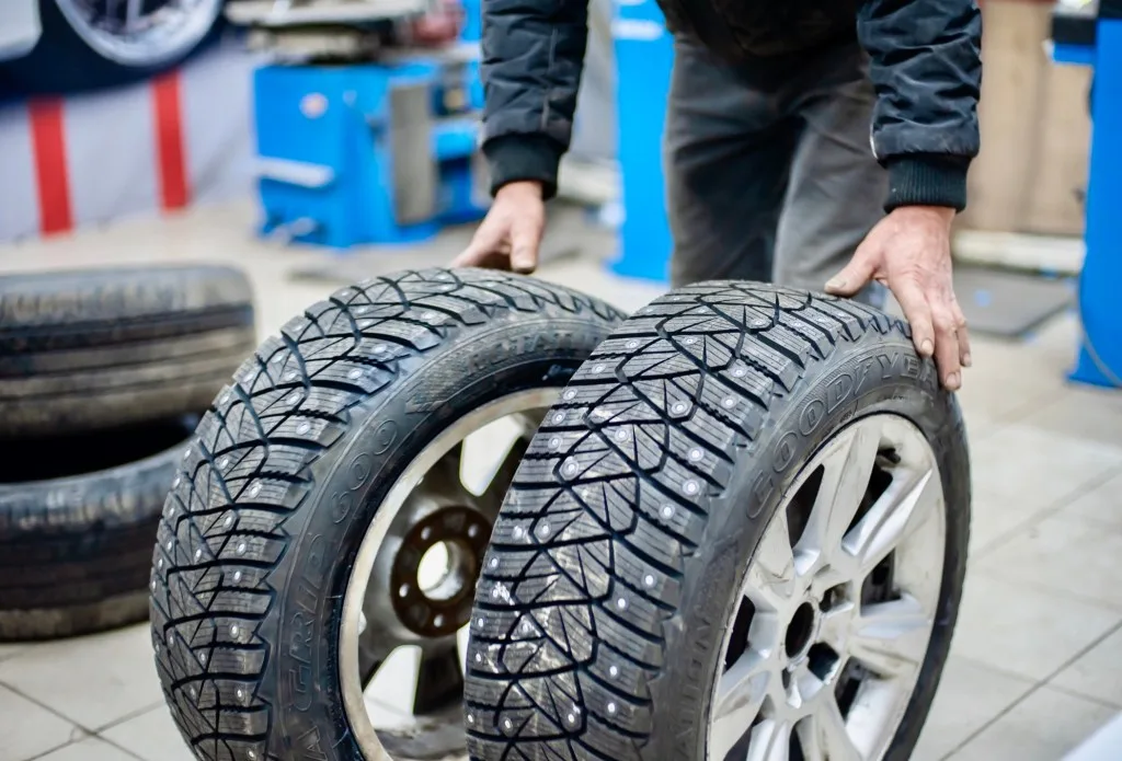 Mechanic putting on a new tire set.