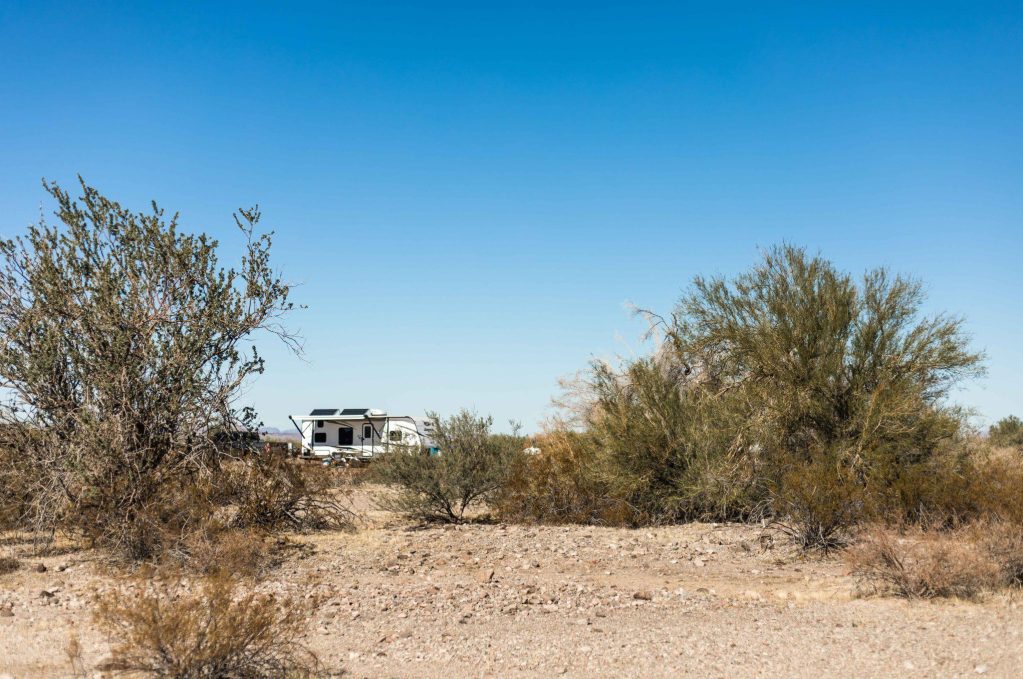 RV with solar boondocking in desert.
