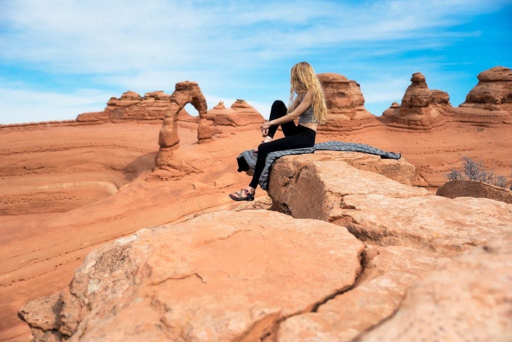 Woman posing while hiking in Arches National Park.