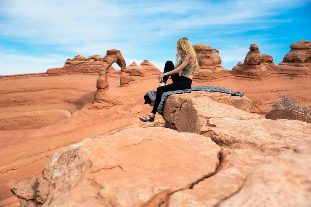 Woman posing while hiking in Arches National Park.