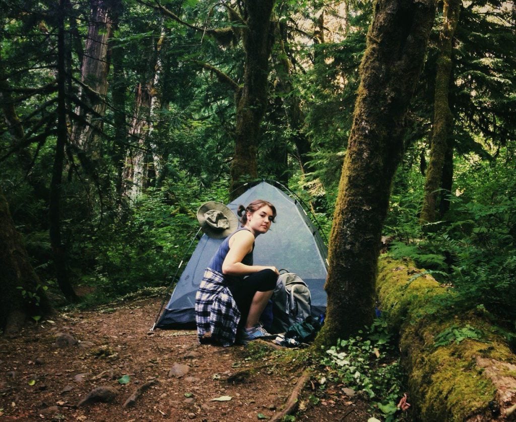 Woman primitive camping in forest