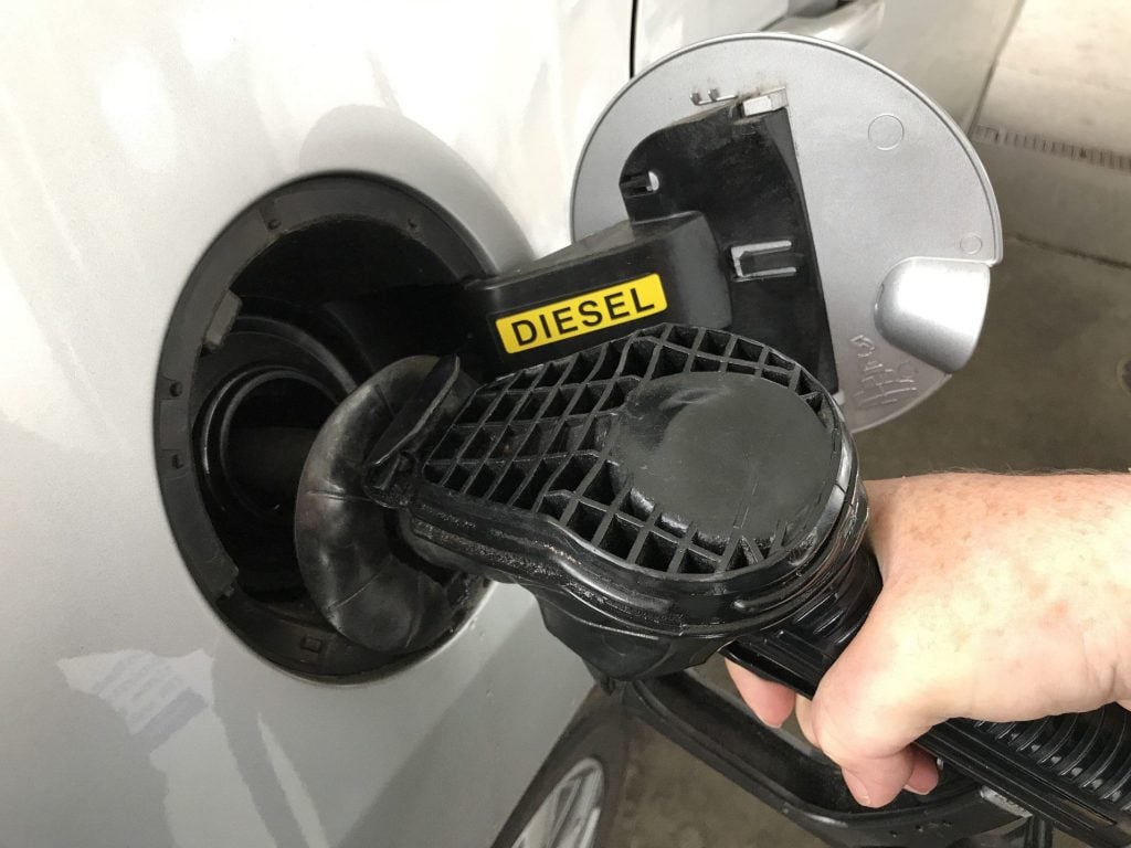 Man filling up car with diesel.