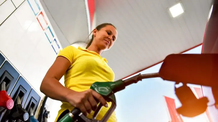 Woman refueling at a gas station