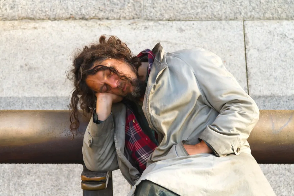 Man sleeping on park bench