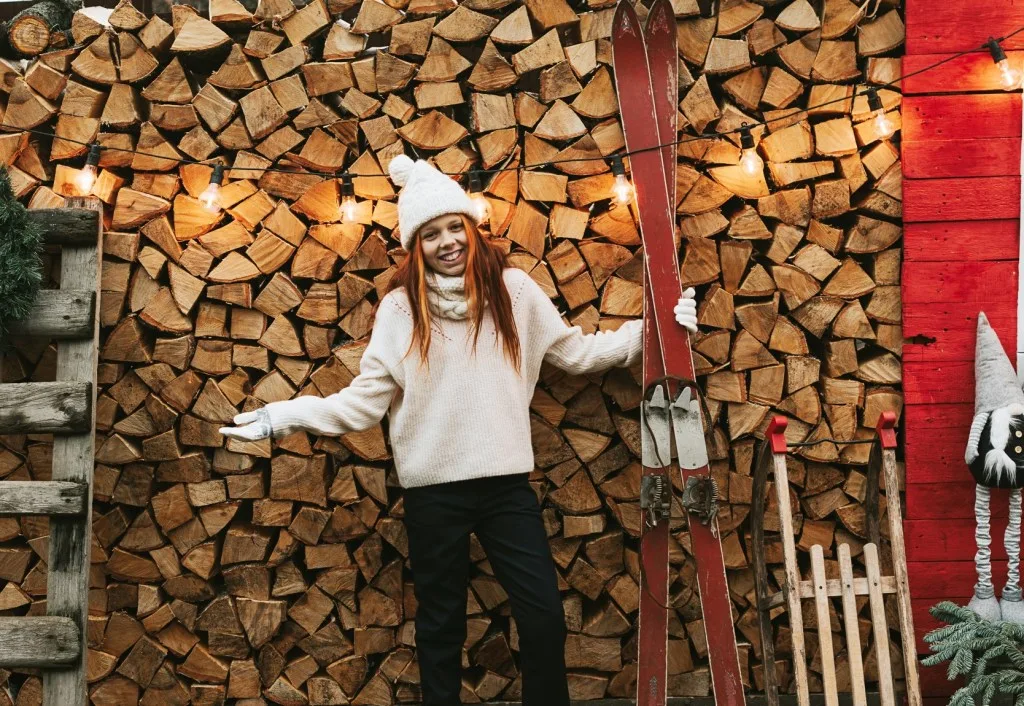 Woman posing in front of barndominium. 