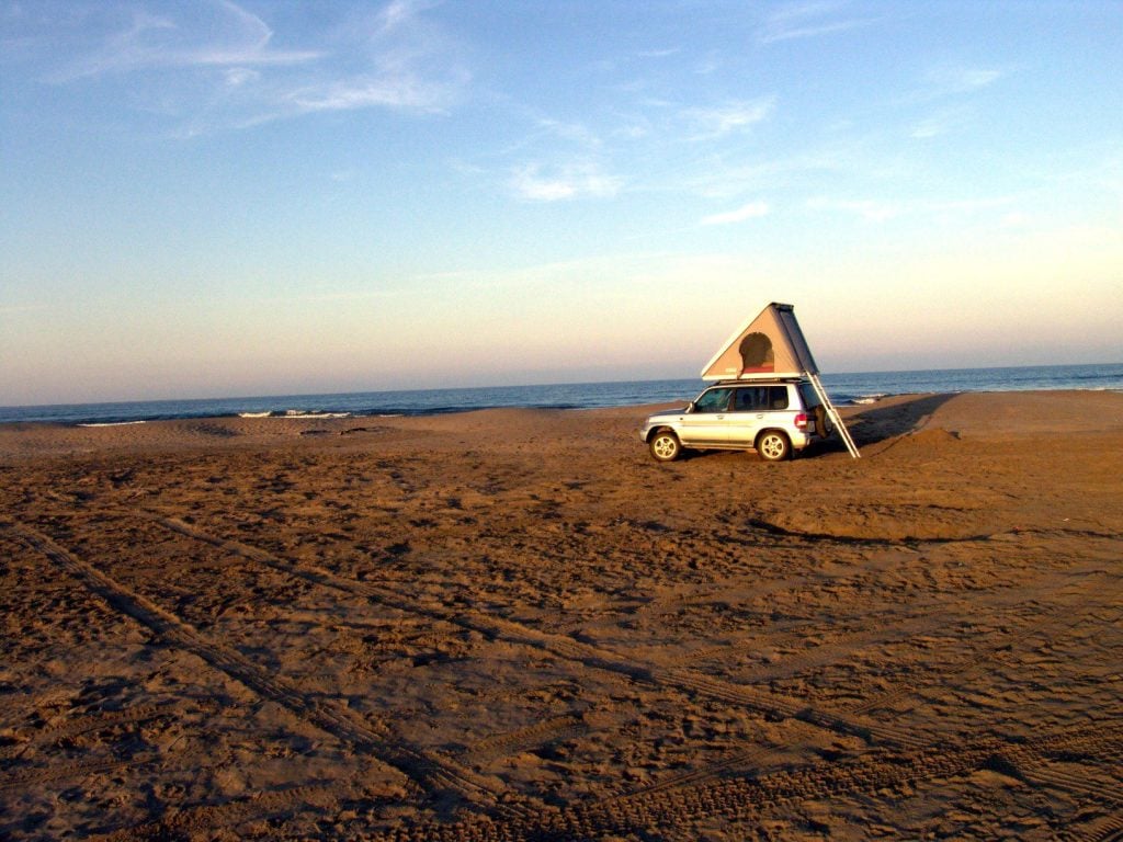 Camper vehicle parked on sand in Texas.