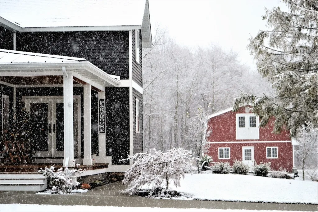 Red barndominium home in the snow.