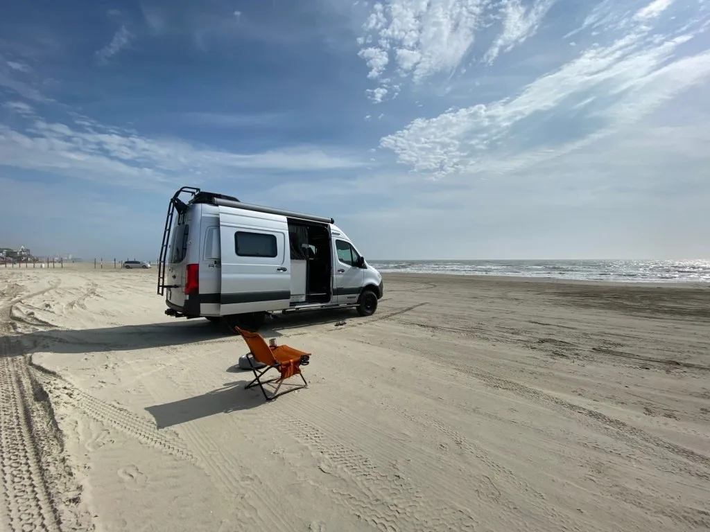 Class B camper van parked on beach
