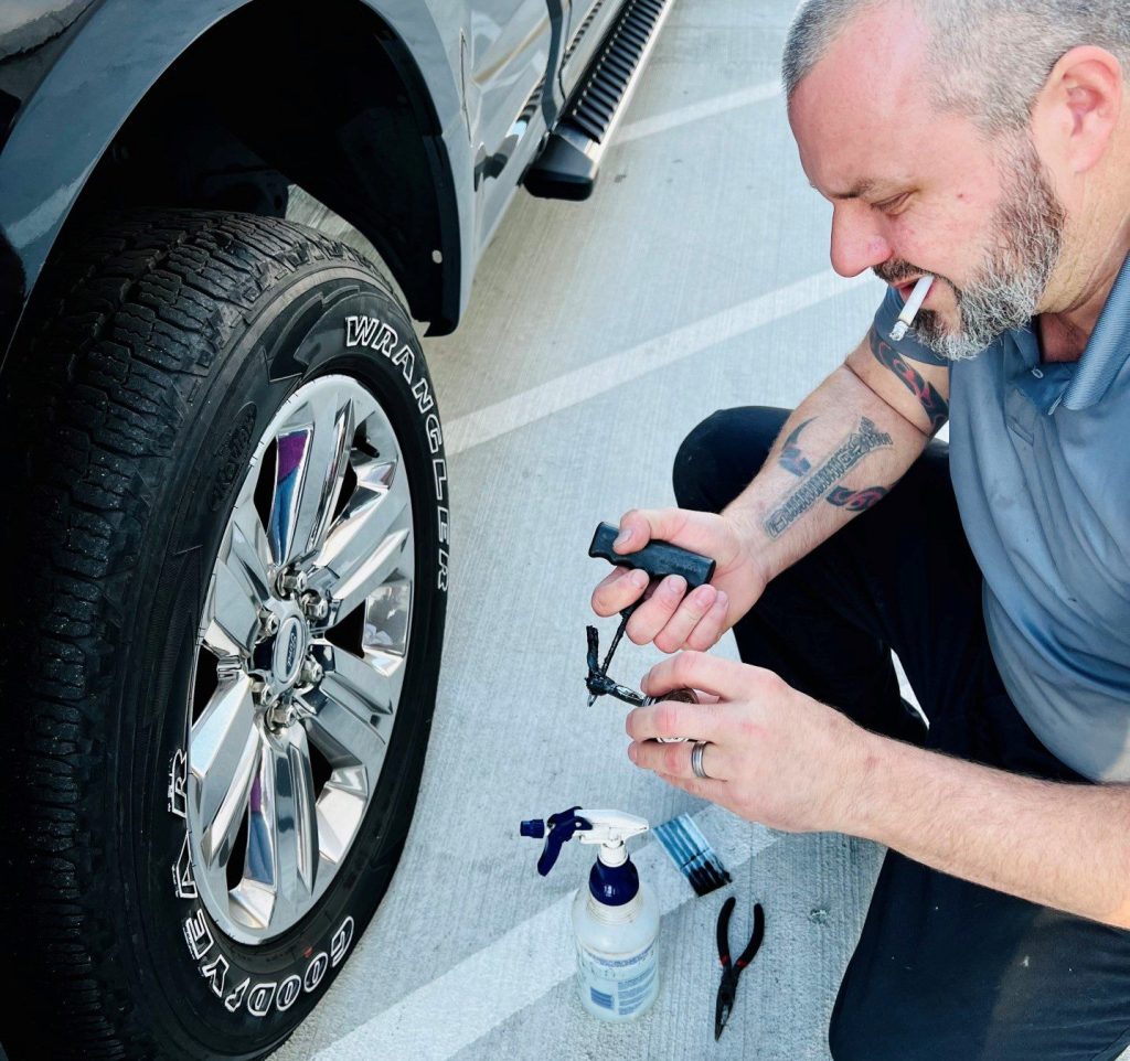 Man patching tire with tire plug kit