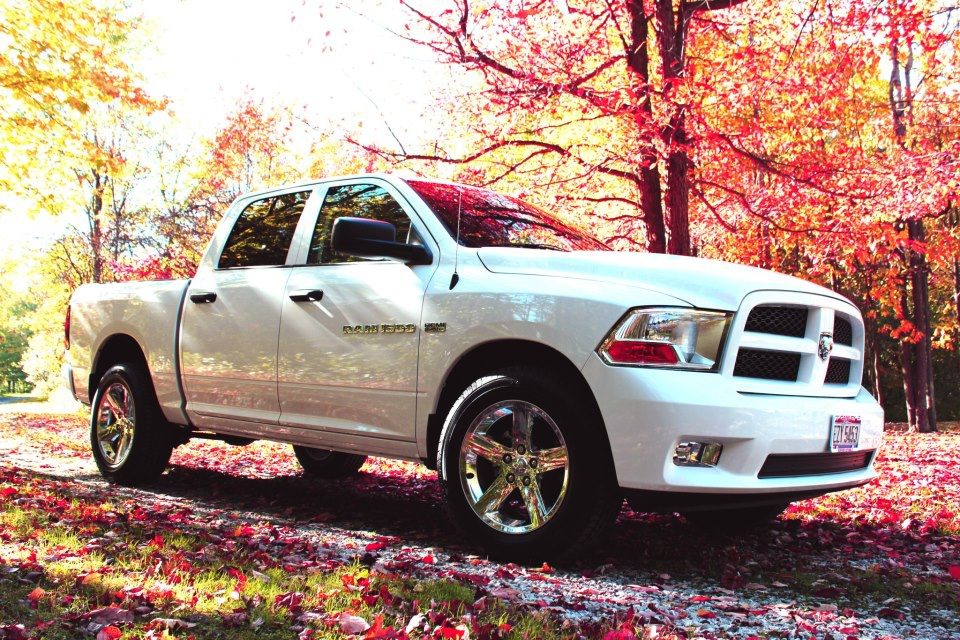White Ram truck parked in driveway in the fall