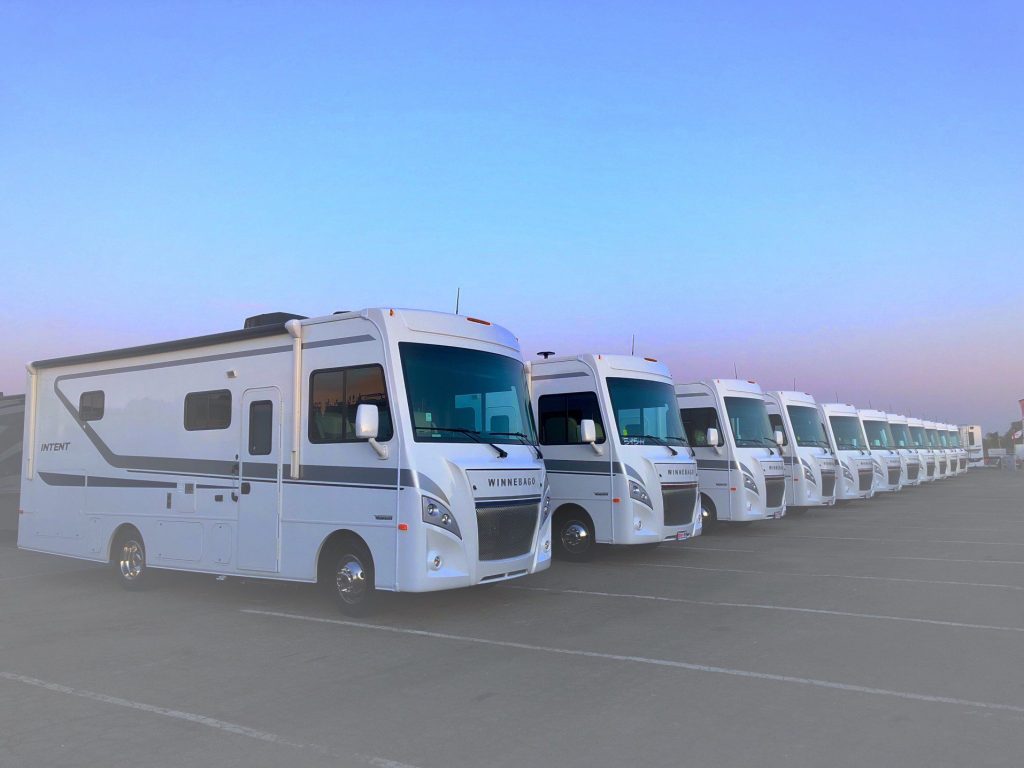 Winnebago RVs lined up in parking lot.