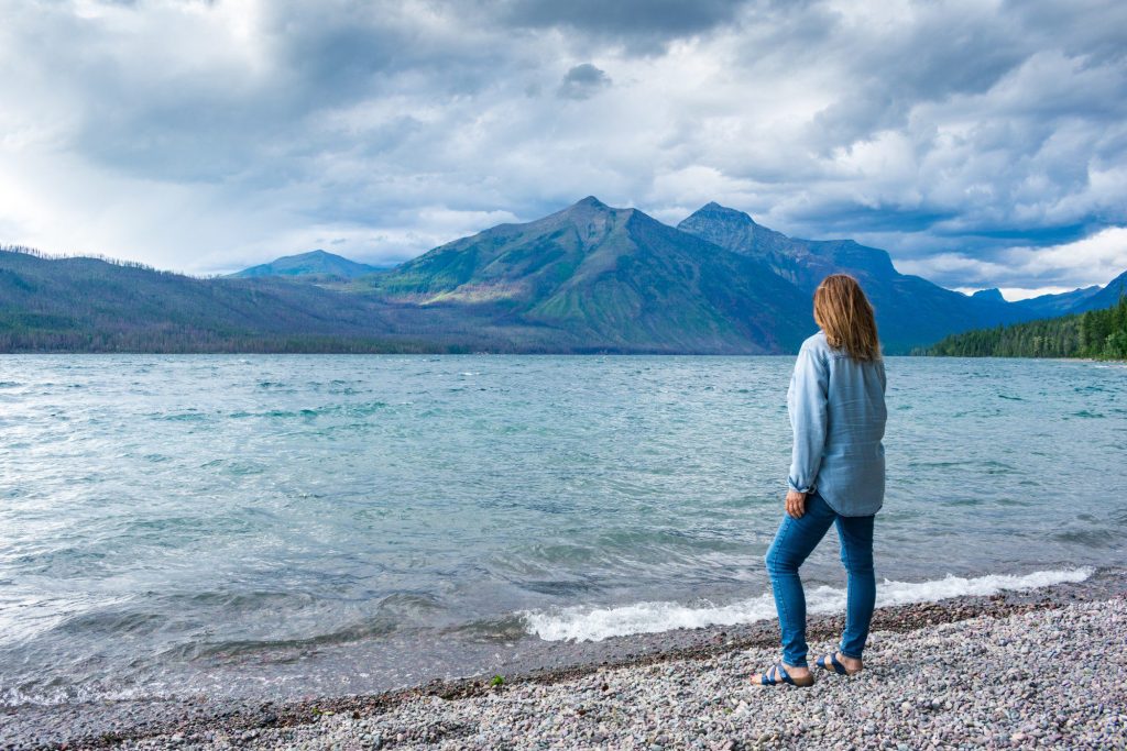 Woman posing in front of lake in Glacier National Park.