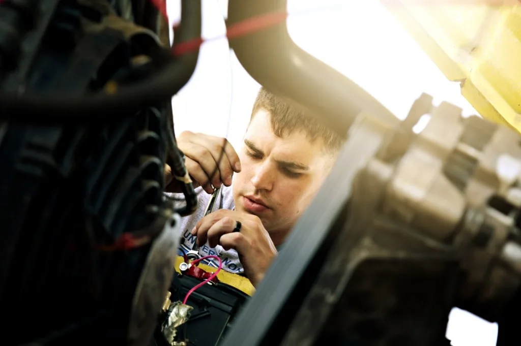 Mechanic repairing engine.
