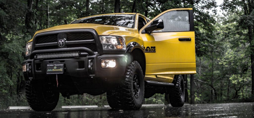Yellow RAM truck parked in a forest