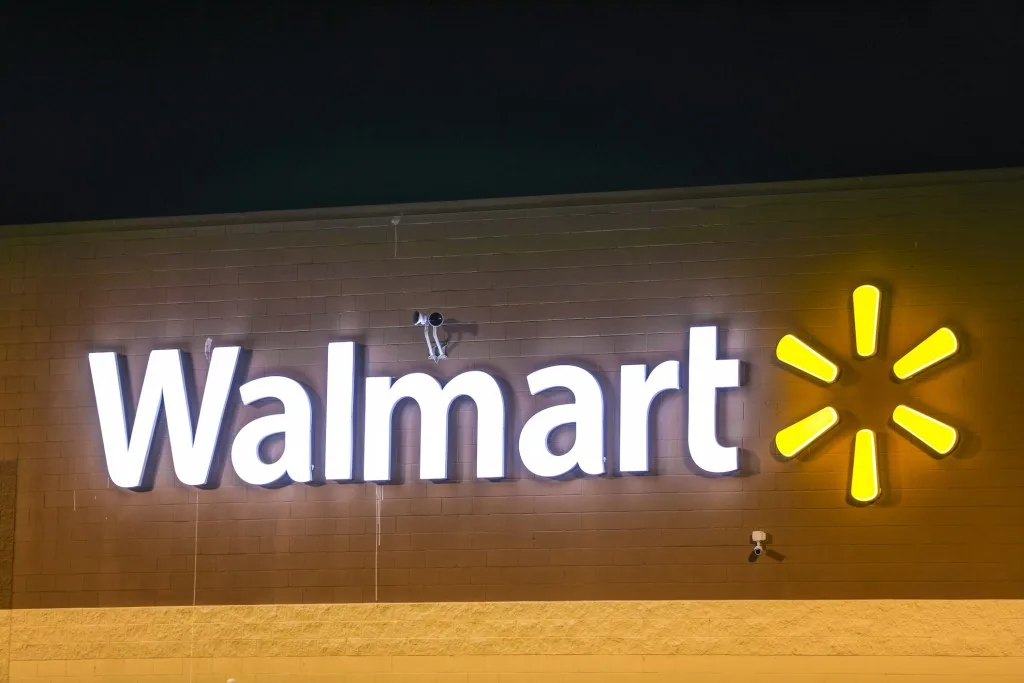 Walmart sign lit up at night.