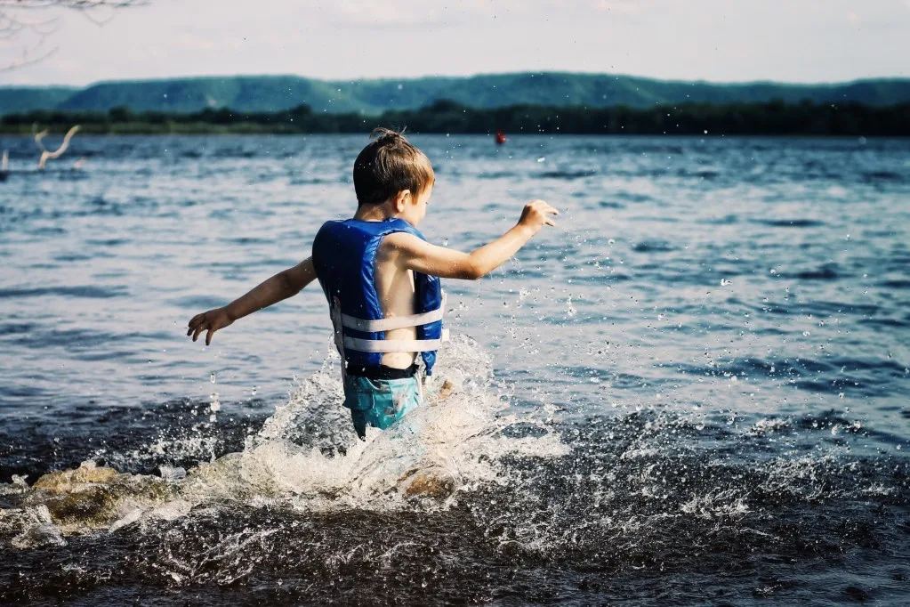 Boy splashing in the Mississippi River