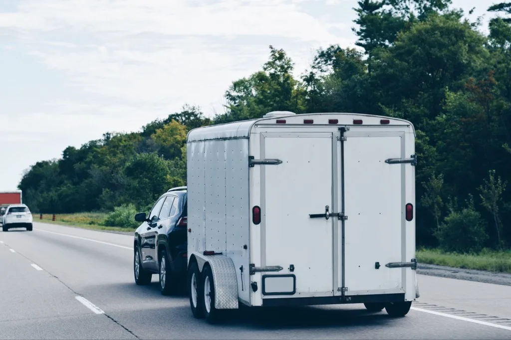 SUV towing travel trailer on highway