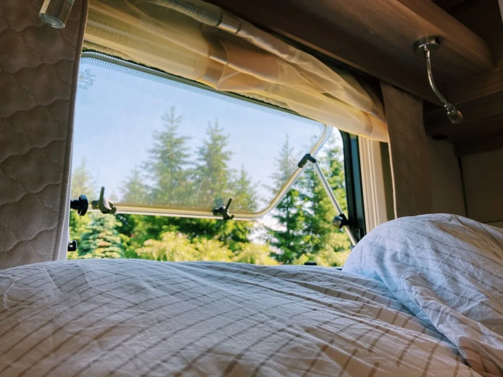 Bed inside RV camper while stealth camping.