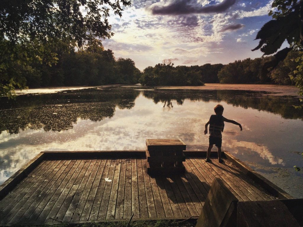 Boy playing on dock along Mississippi