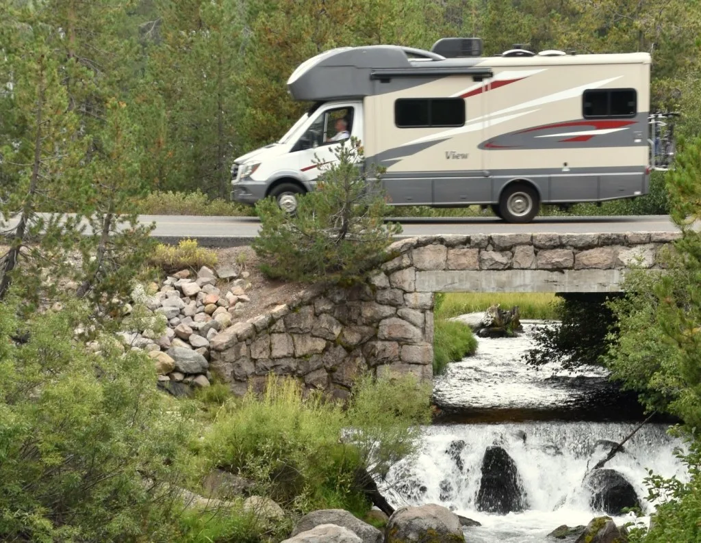 RV driving over bridge and river