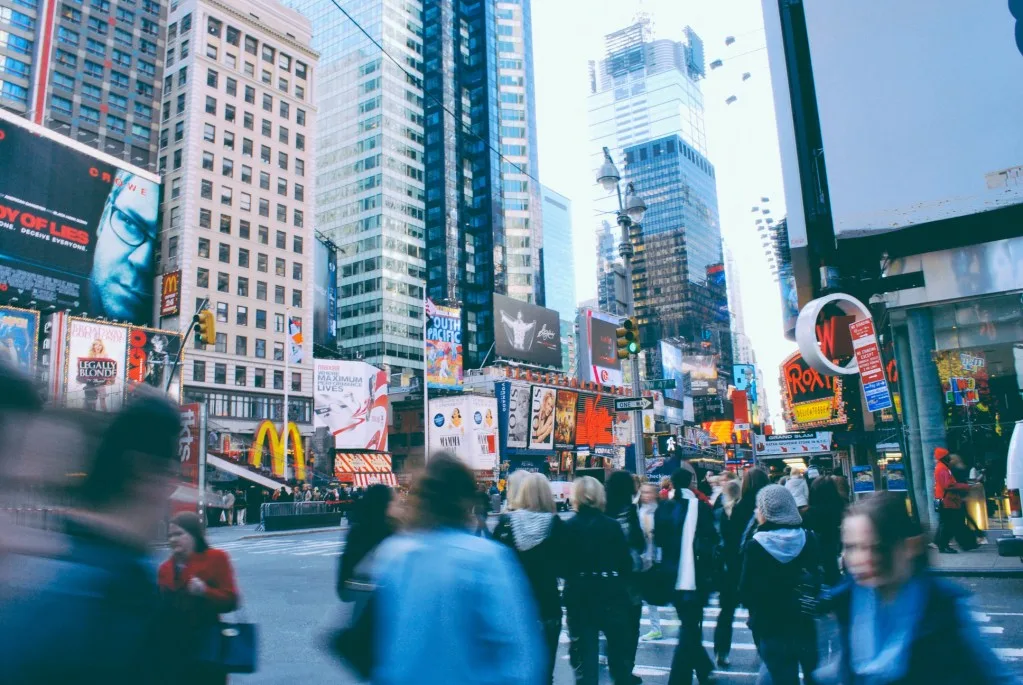 Crowds walking quickly in Times Square.