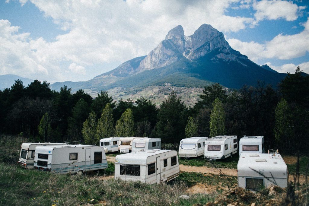 RVs parked at a RV park at the base of a mountain.