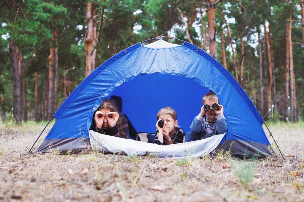Siblings camping in tent in Smoky Mountains