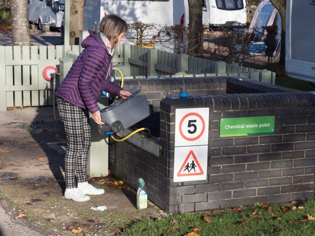 Woman emptying cassette toilet collection tank