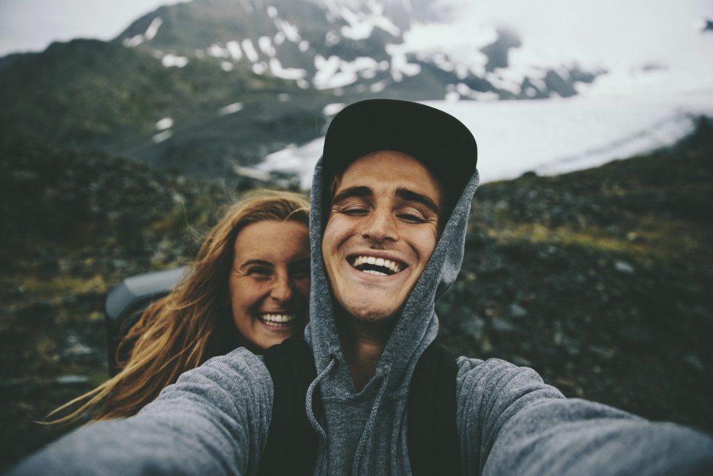 Couple smiling and taking a selfie in Alaska