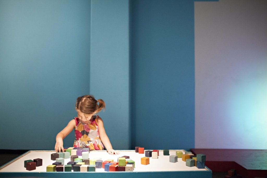 Little girl playing with museum display