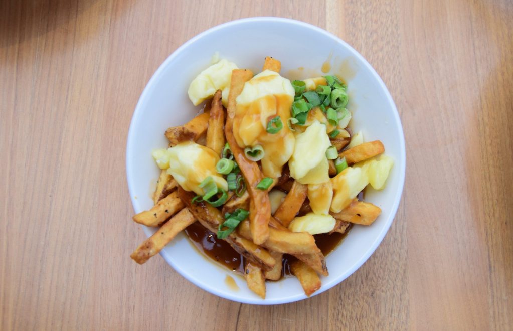Plate of poutine on a table