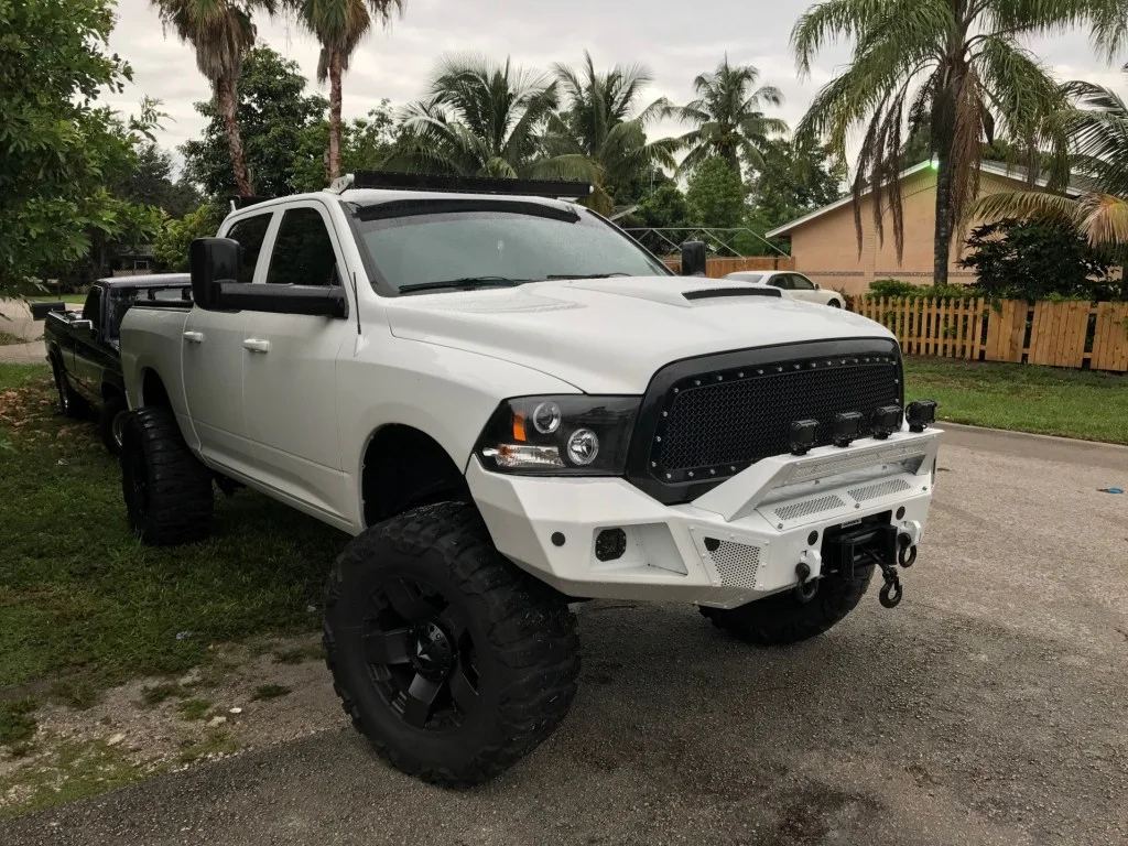 White truck with light bar installed on bumper
