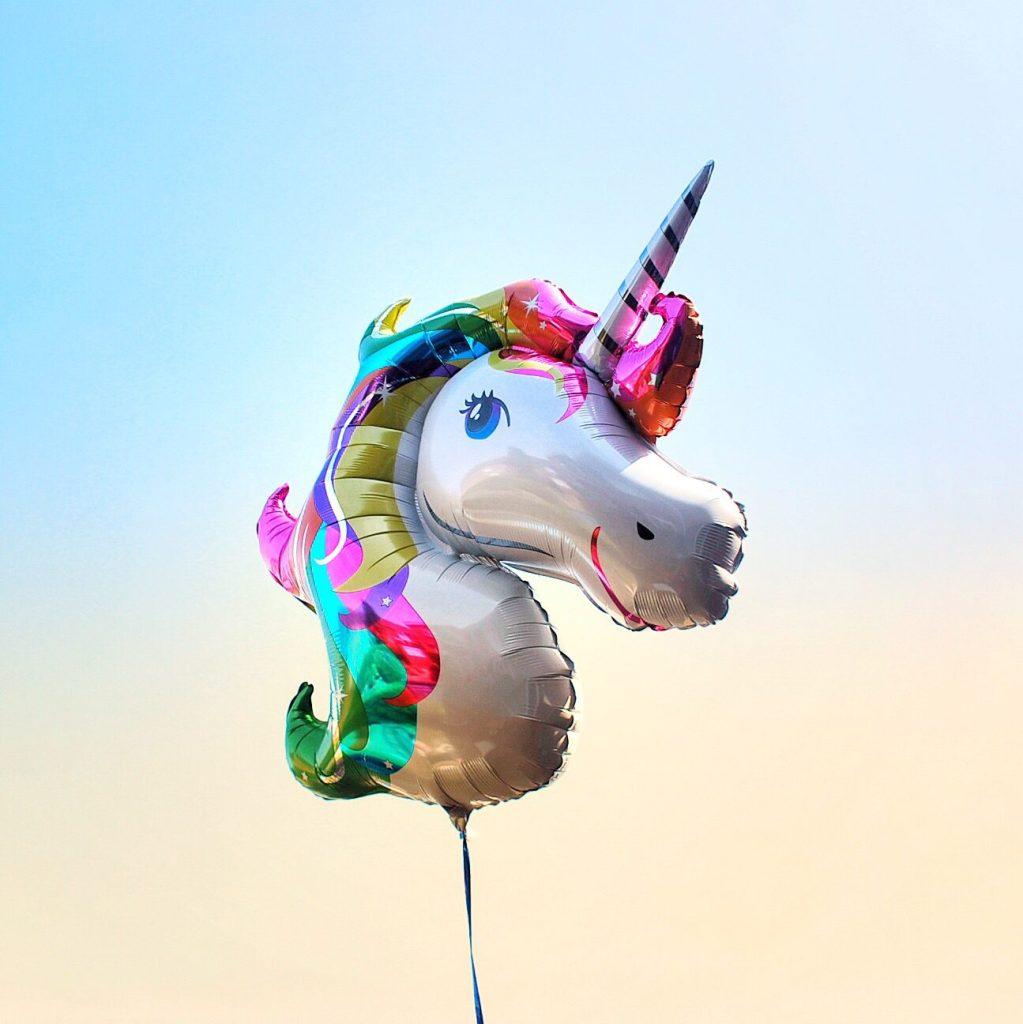 Unicorn balloon in the style of Lisa Frank.