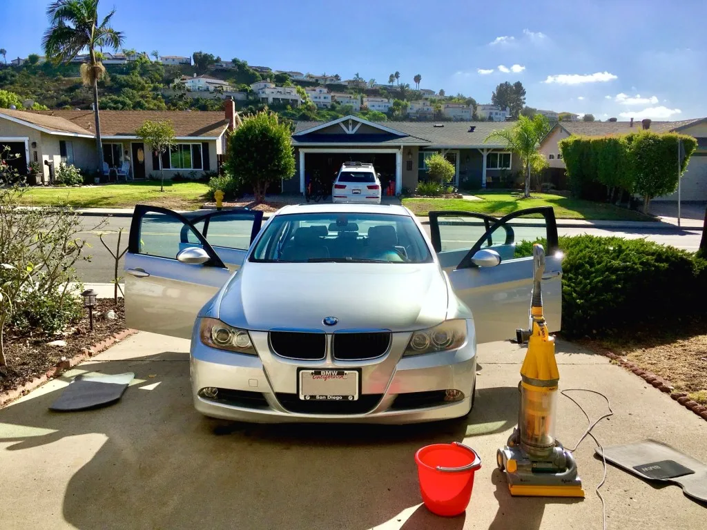 Car parked in driveway being cleaned.
