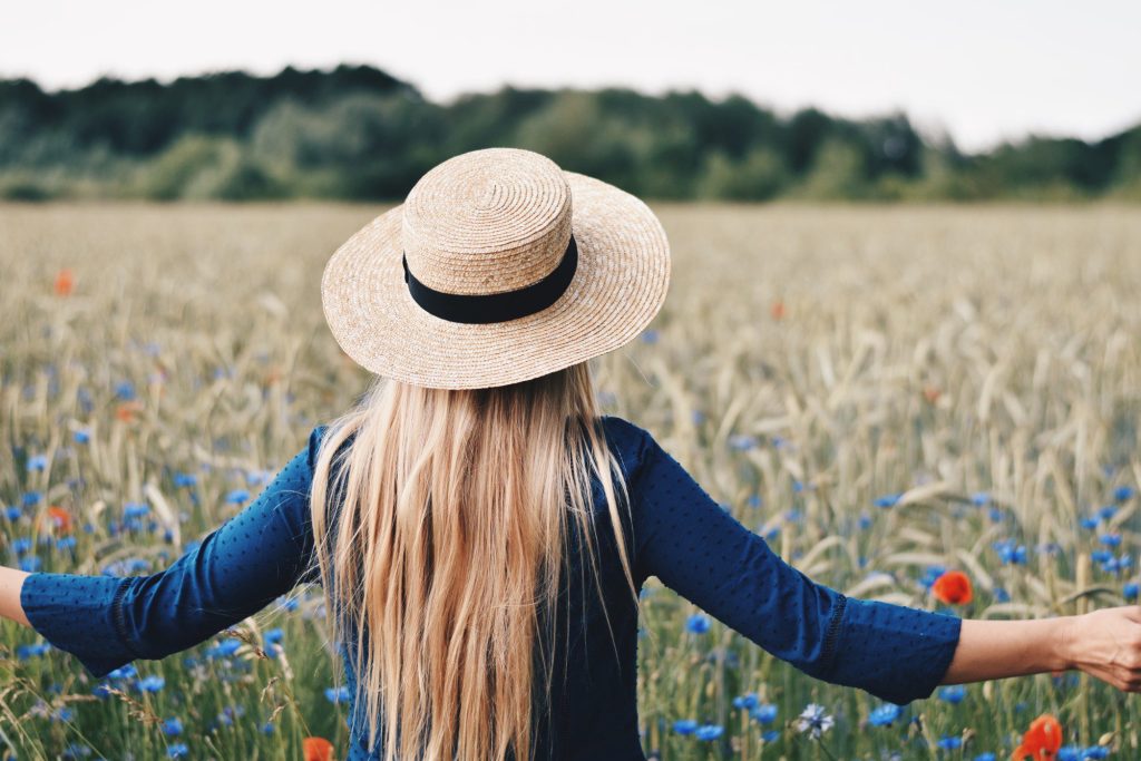 Woman walking in flower field. 