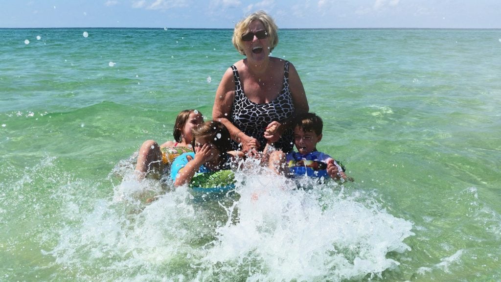 Grandma and three grandkids swimming in Belle Isle Beach