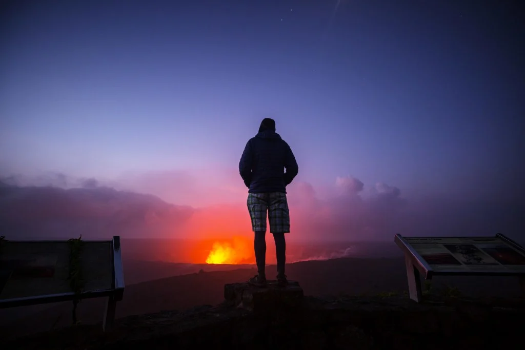 Man standing in front of Kilauea Active Volcano on Big Island, Hawaii
