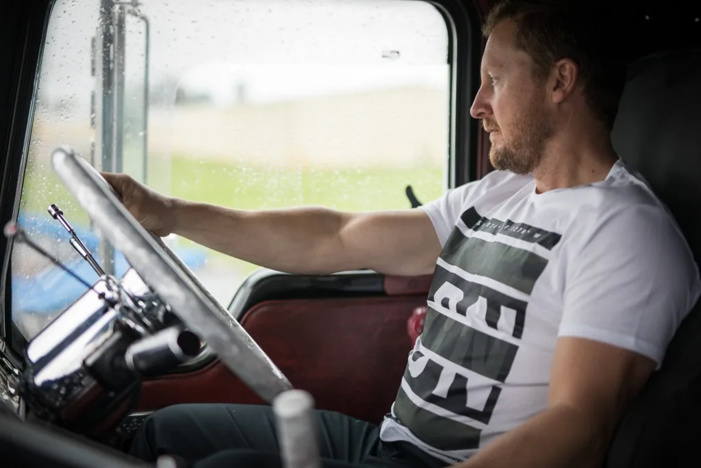 Inside truck as a trucker drives on highway