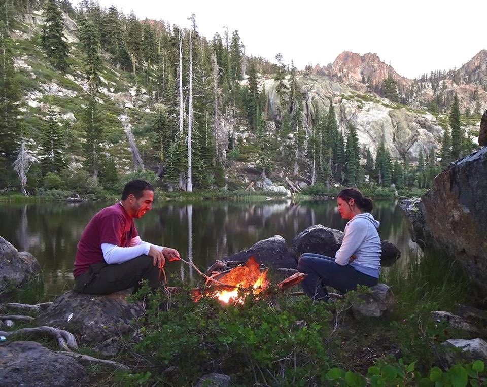 Couple sitting at a campfire in BLM forest