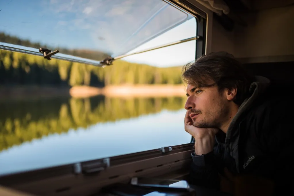 Man looking out window of RV