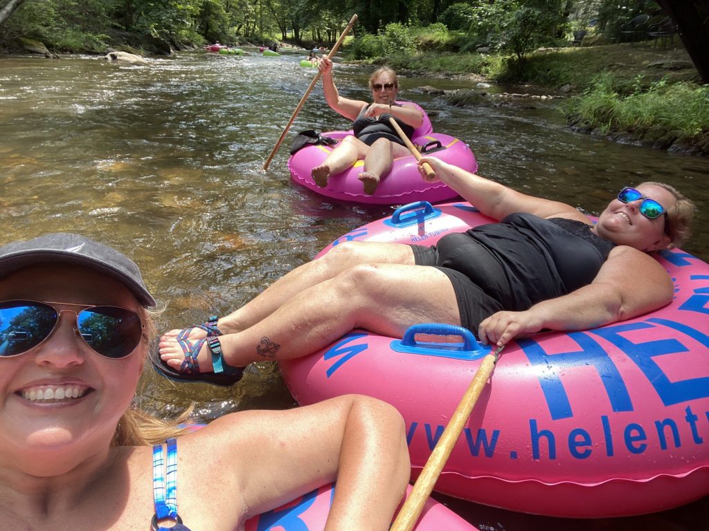 Three friends tubbing along the Chattahoochee River