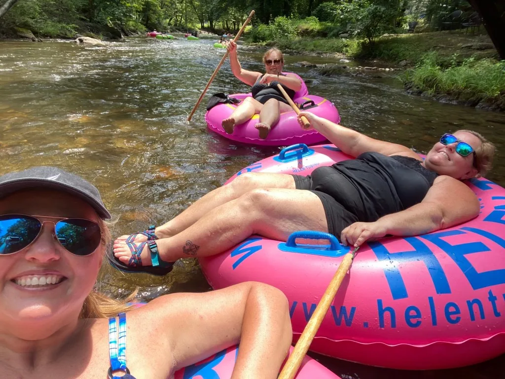 Three friends tubbing along the Chattahoochee River