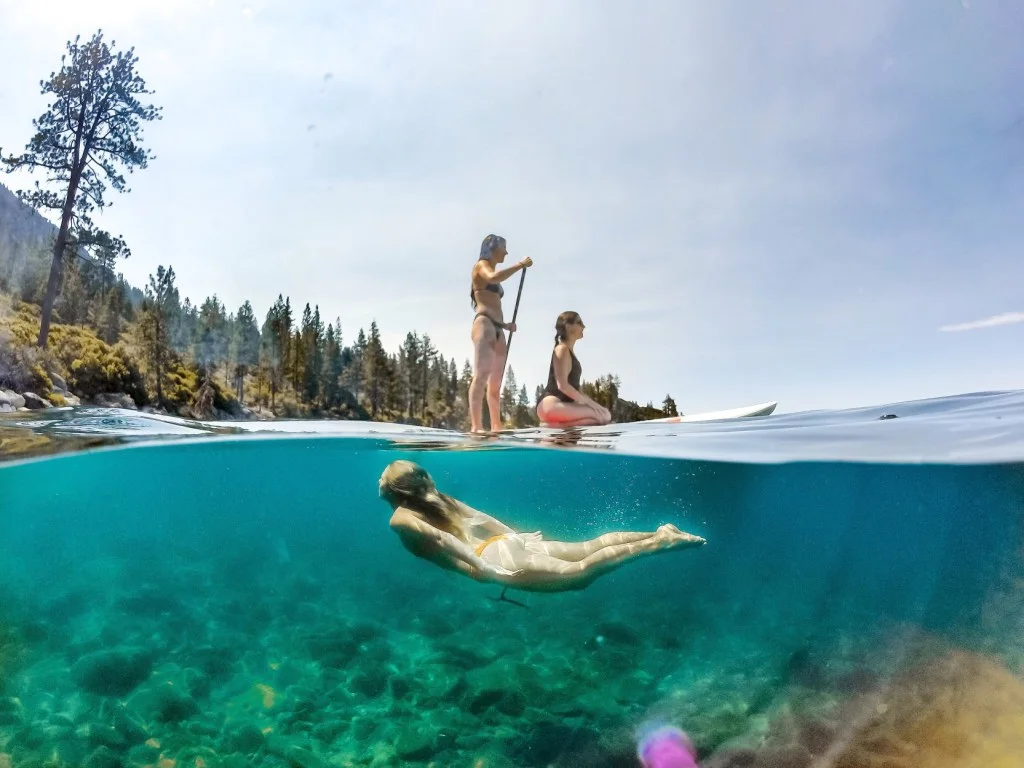 Three girls swimming and paddle boarding at Lake Roosevelt