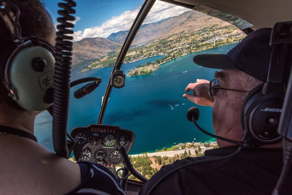 Woman and man in helicopter flying over Lake Chelan