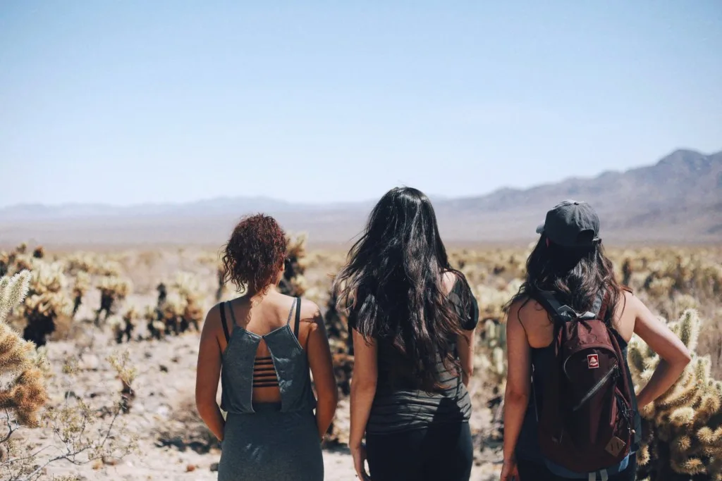 Three female friends walking through native American land