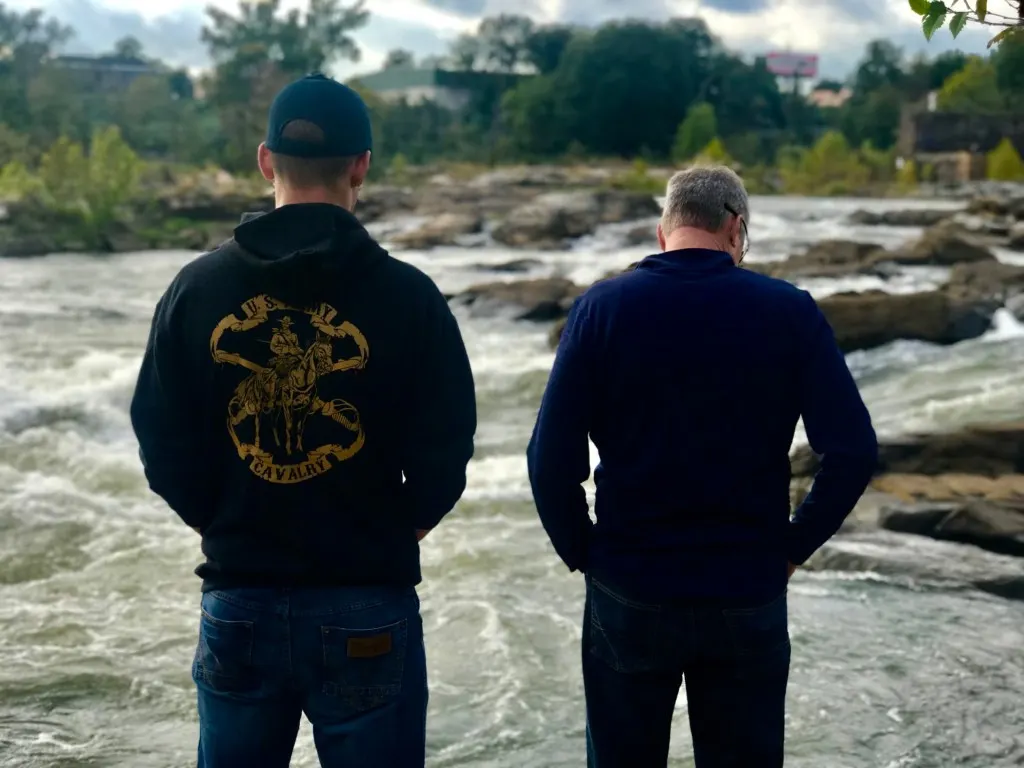 Father and son looking out together at the Chattahoochee River