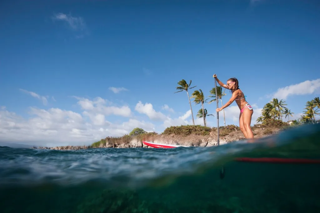 Woman paddle boarding in Hawaii