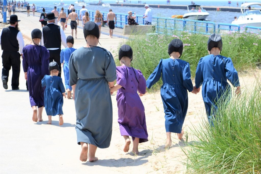 Amish girls walking together hand in hand