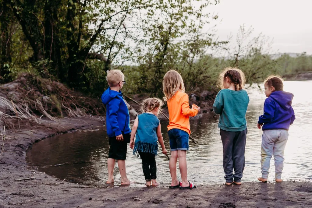 Kids standing next to one of the dirtiest rivers in the USA