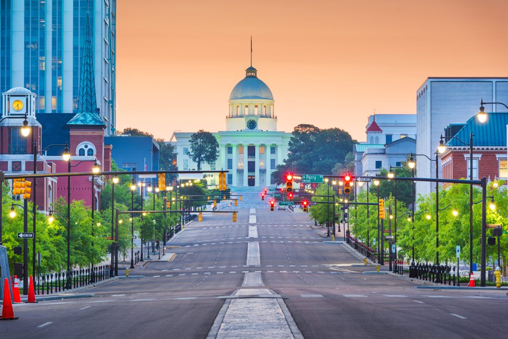 Montgomery, Alabama, USA with the State Capitol and cityscape at dawn.